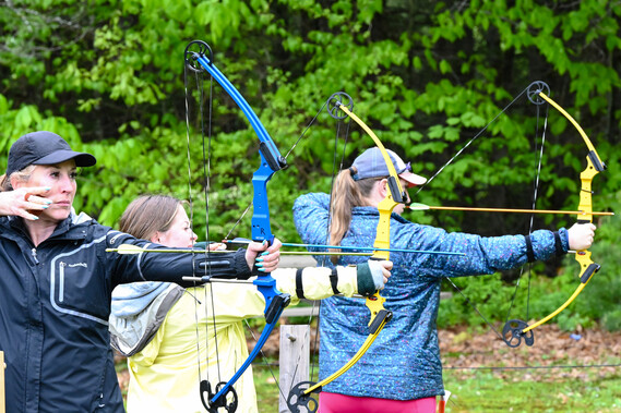 women shooting archery