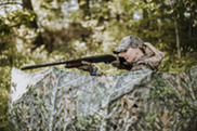 Female hunter hunting from a blind with a shotgun