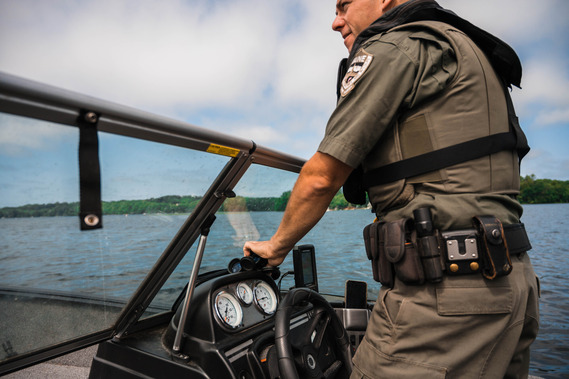 Game Warden driving motor boat