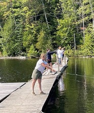 People fly casting on a dock