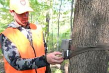 hunter placing a game camera