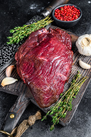 deer meat with herbs on wooden cutting board