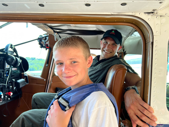 child in float plane with Maine Game Warden