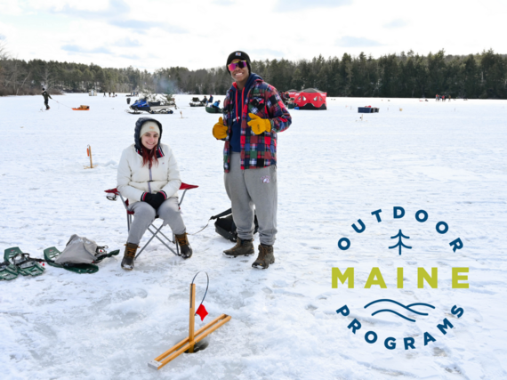 Two people happy to be ice fishing together during a winter event.