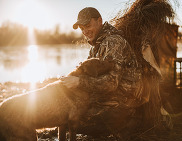 duck hunter smiling at dog