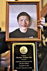 Top: framed photo of Matthew William Otte. Bottom: his award.
