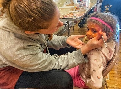 This is a graphic showing a Child having her face painted