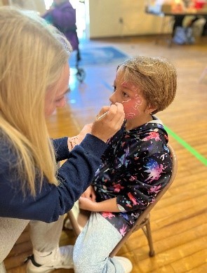 This is a graphic showing another Child having her face painted