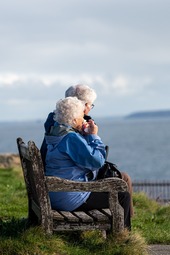 Two people looking at the ocean