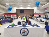 Person sitting at a table at a resource fair