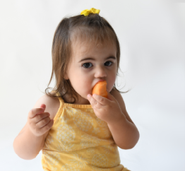 child eating a pepper