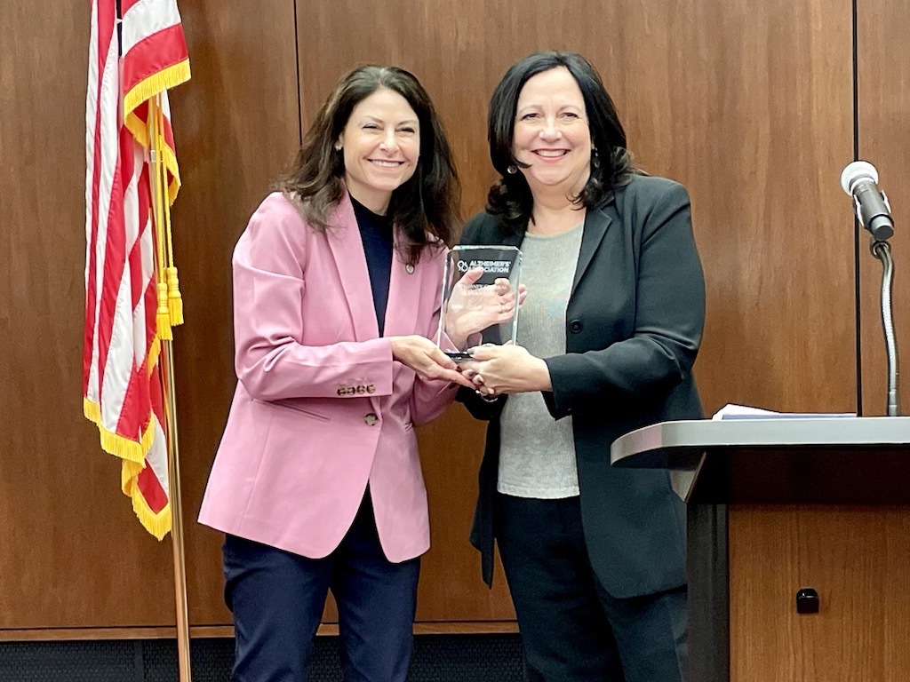 Dana Nessel receives Excellence in Leadership Award from Jennifer Lepard, President & CEO of the Michigan Chapter of the Alzheimer's Association.