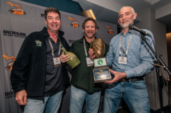 Photo of owners of Dog Star Hops being presented a Chinook Cup trophy by Alec Mull