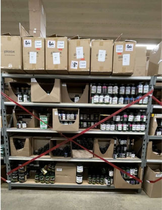 Photograph of cardboard boxes containing unapproved products placed under MDARD seizure