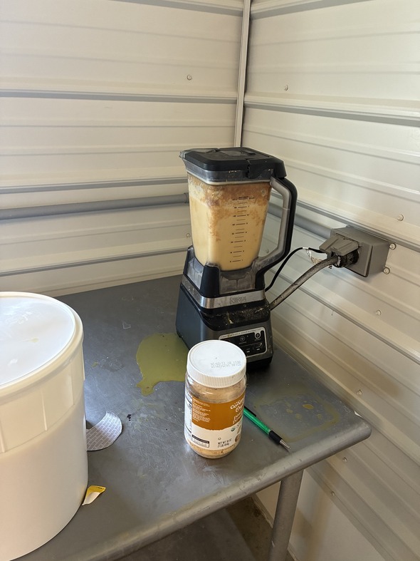 Photograph of a blender containing a powdered peanut butter ingredient.