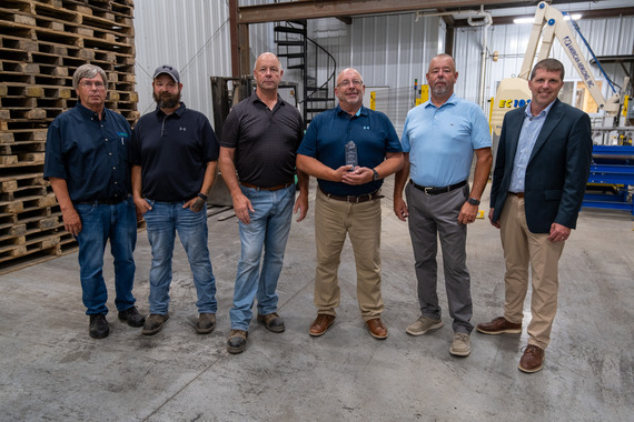 Photo of MDARD Director Tim Boring presenting the Ag Exporter of the Year award to Roger Hupfer and employees at Freeland Bean & Grain