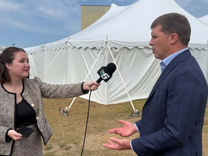 Photograph of MDARD Director Tim Boring speaking with a reporter at the UP state fair