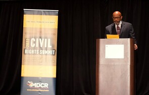 Photo of MDCR Director Johnson behind the podium at the 2022 Civil Rights Summit