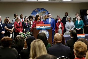 Governor Whitmer behind the podium speaking at voting rights press conference 