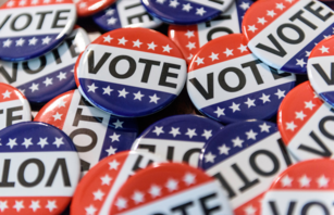 Red, blue, and white campaign buttons with the word "Vote" 