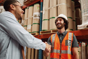 Men shaking hands in a warehouse