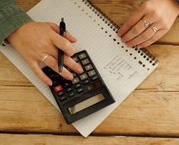 Person using a calculator to make a budget
