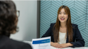 Person sitting across a desk doing in a job interview