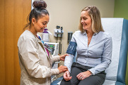 healthcare apprentice taking someone's blood pressure
