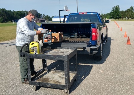 Household hazardous waste in back of pickup truck being dropped off at collection event. 