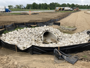 Soil erosion and sedimentation control measures implemented at a newly constructed storm water culvert.