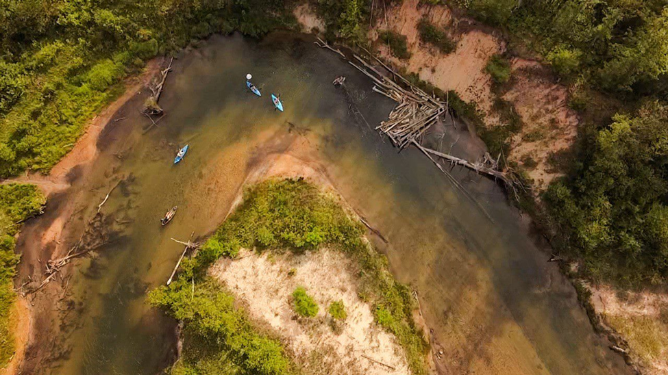 Kayakers on a river bend