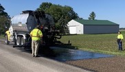 Installation of rubber modified chip seal on 7 Mile Road in Bay County. 