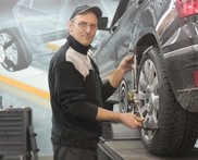 Person working on tire maintenance in shop.