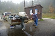 Person washing boat at Higgins Lake boat wash station. Photo courtesy of DNR.