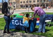 People interact with EGLE Lending Station at event in Muskegon in May 2022.