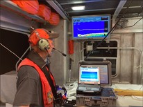 Monitoring midwater trawl depth and hydroacoustic targets during a survey in Saginaw Bay, Lake Huron. (Photo courtesy of DNR.)