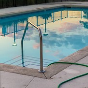 Outdoor in-ground swimming pool showing poolside steps