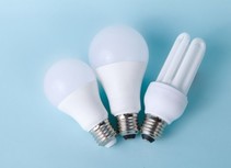 Three LED light bulbs on a blue background.