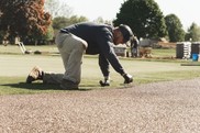 Worker installs a Porous Pave pathway at Spring Meadows Country Club in Linden, Mich. (Photo courtesy of Porous Pave.)