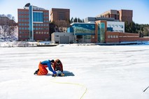 Scientists deploy a remotely operated vehicle through the ice. (Photo courtesy of Michigan Technological University)