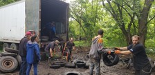 People loading scrap tires into a truck in Battle Creek.