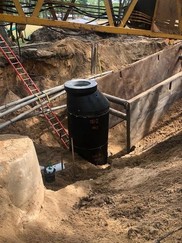 Pipe installation showing placement of sanitary sewer manhole in easement.