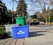 Recycling bins curbside awaiting pickup. 