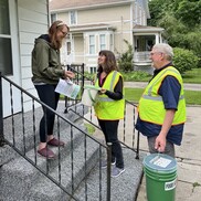 Emily Piper, left, with Iris CEO Sarah Archer and her husband, Darrell Reed, discusses details of new food scrap collection pilot program.