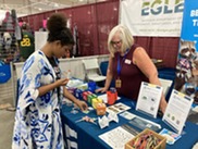 Chrissie Pearce answers a person's question at the EGLE exhibit at the Upper Peninsula State Fair in 2022.