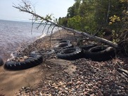 Illegally disposed scrap tires on a beach in Ontonagon.