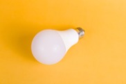 LED light bulb on yellow background. Photo from Pexels by Riki Risnandar.