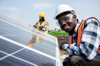 Two technicians installing heavy solar photo voltaic panels to high steel platform in corn field - agrivoltaic land use produces clean, green energy. 