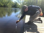 Geoff Rhodes sampling for PFAS from a river