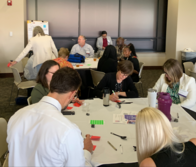 People working around a table to give feedback